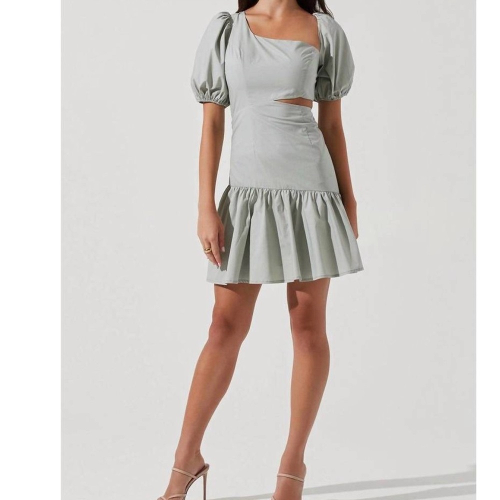 Mayfair Dress asymmetrical neckline with a side cutout accent with  ruffle trim.